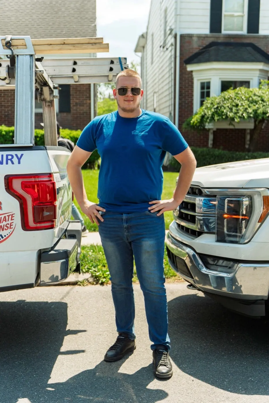 American Roofing crew member beside a company truck