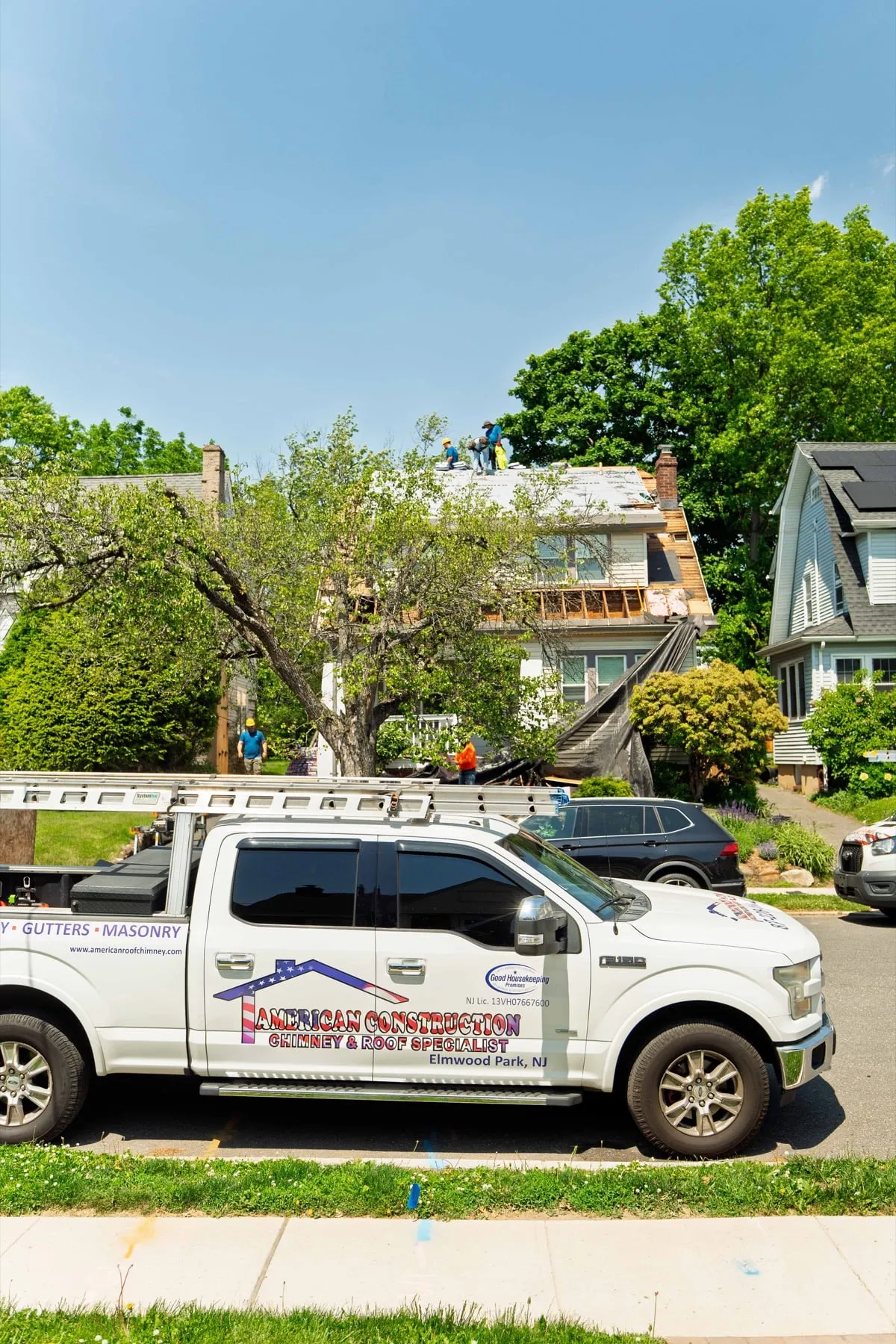 Company truck loaded with ladders at a job