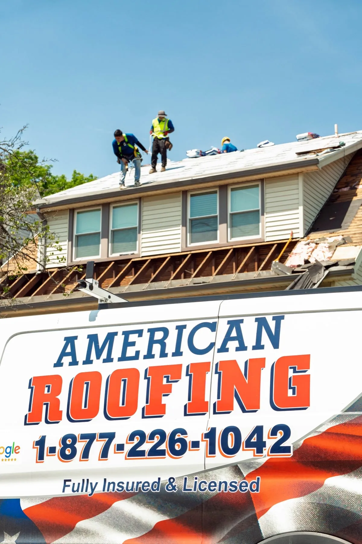 American Roofing van outside a house with the crew working