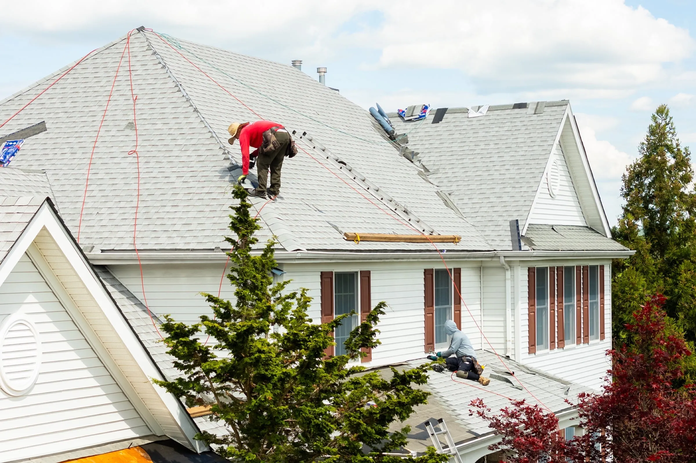 Crew installing new shingles